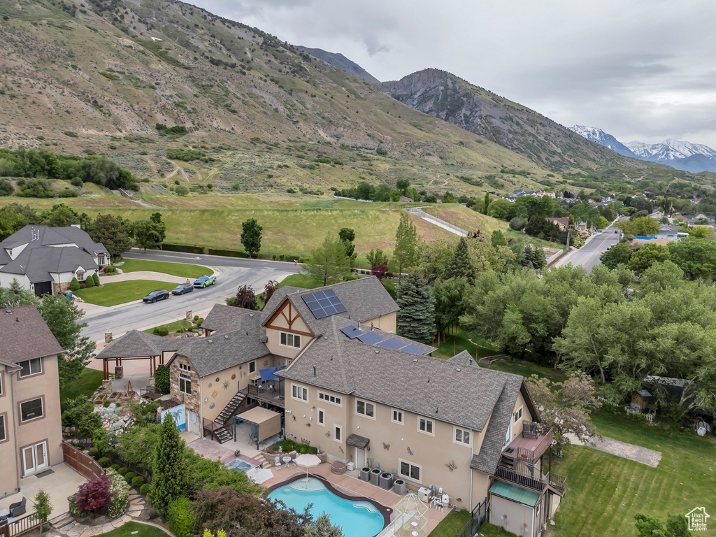 Aerial view of residential area featuring a pool area and mountains