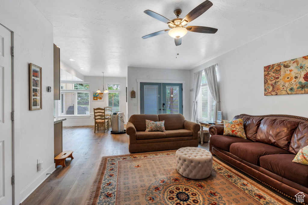 Living room featuring wood finished floors, a ceiling fan, and baseboards