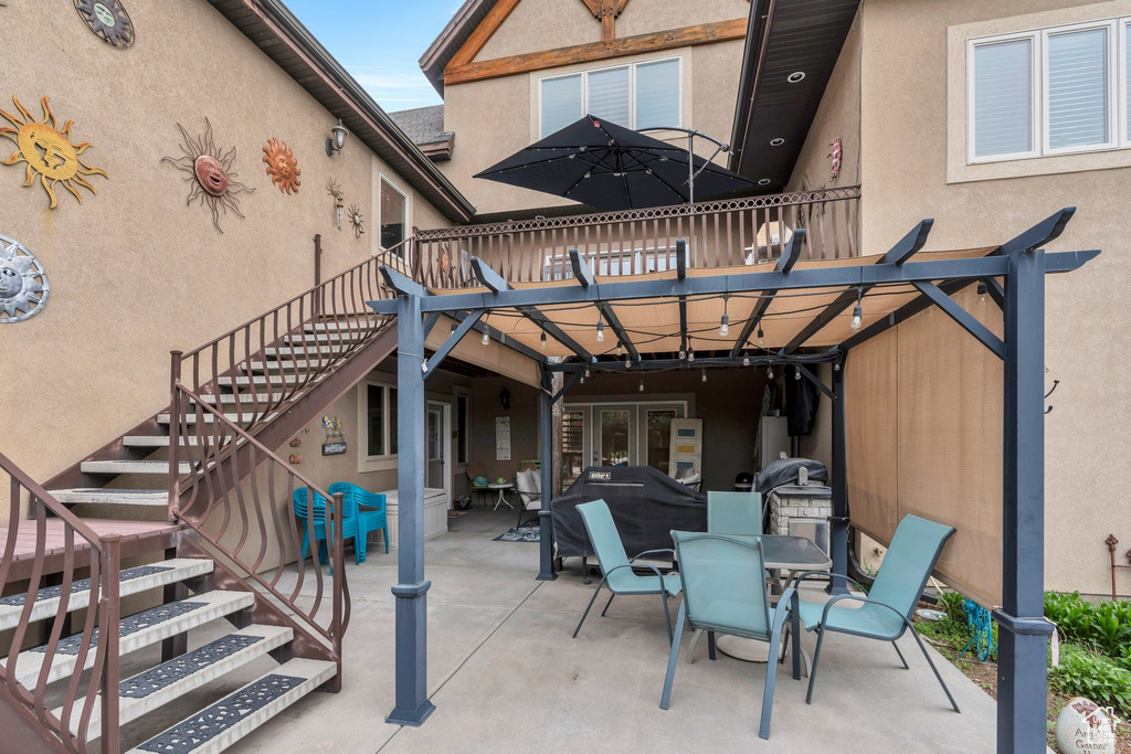 View of patio / terrace featuring stairway, outdoor dining space, and french doors