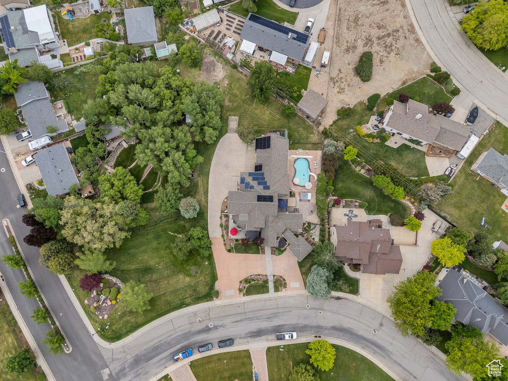 Aerial view of property and surrounding area with nearby suburban area