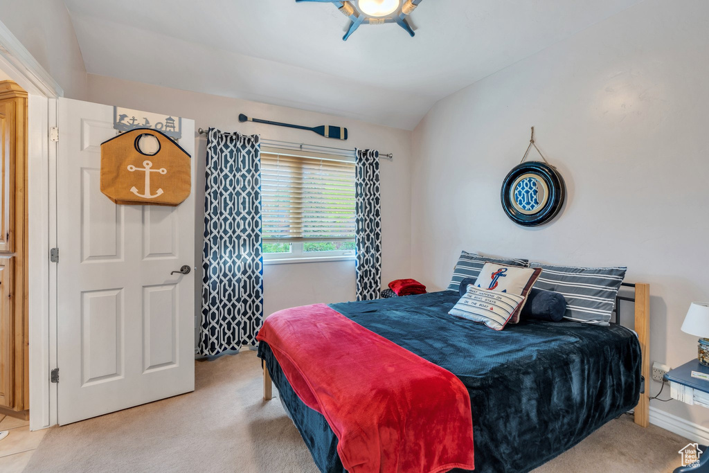 Bedroom featuring light carpet and a ceiling fan
