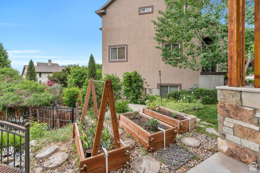 View of yard with fence and a garden