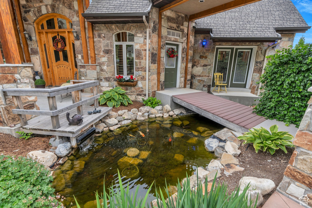 View of patio featuring a garden pond