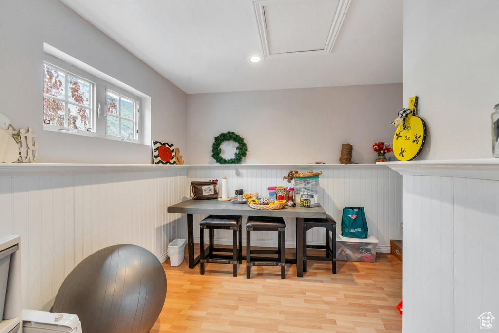 Dining room with a wainscoted wall and wood finished floors