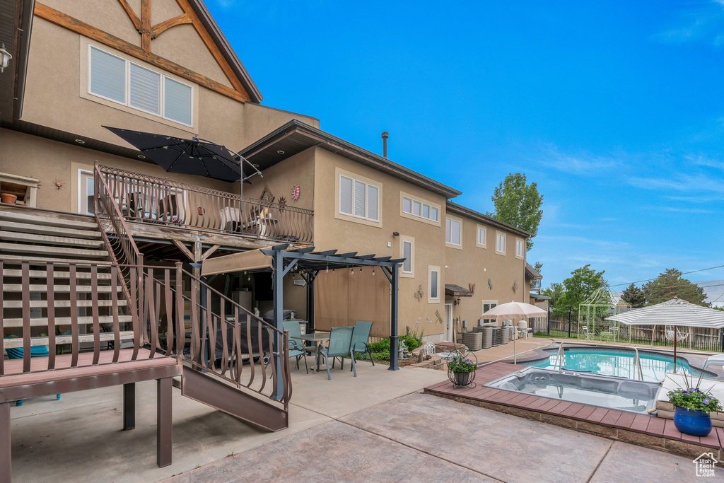View of swimming pool featuring a pergola, a patio, an in-ground hot tub, and outdoor dining space