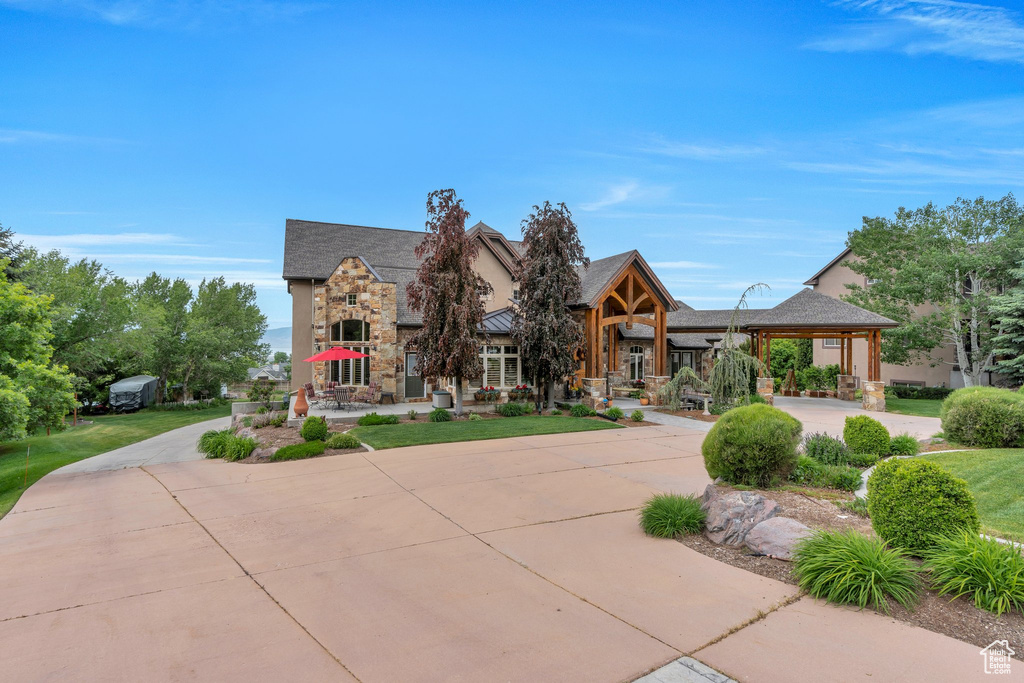 View of front of home with stone siding and a gazebo