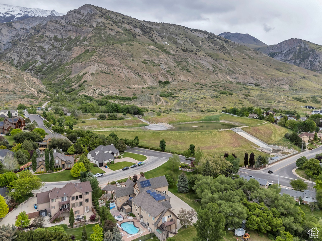 Aerial view of property and surrounding area with nearby suburban area and a water and mountain view