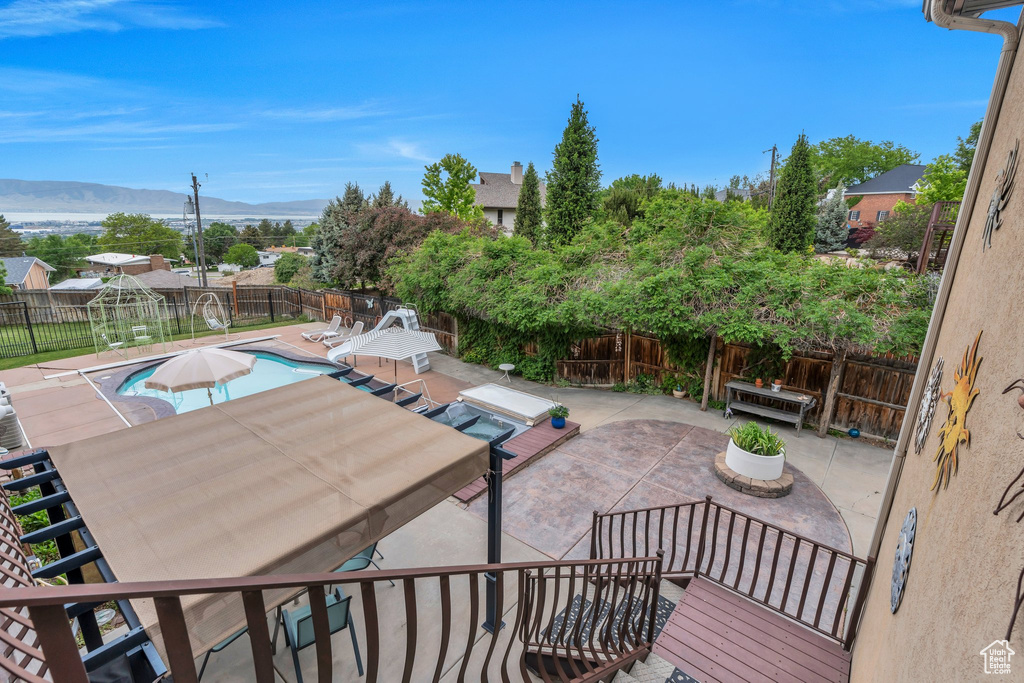 View of patio with a fenced backyard, a mountain view, and outdoor dining area
