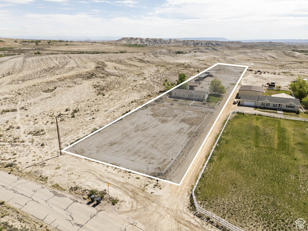 Overview of rural landscape featuring property parcel outlined, a mountain backdrop, and a desert landscape