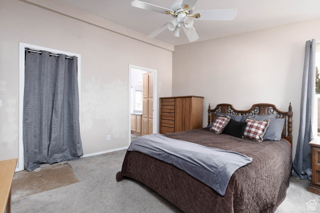 Carpeted bedroom with a ceiling fan and ensuite bath