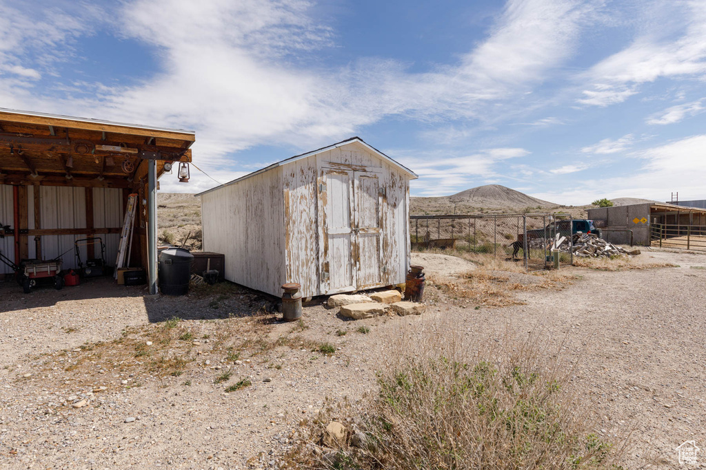 View of shed with fence and a mountain view