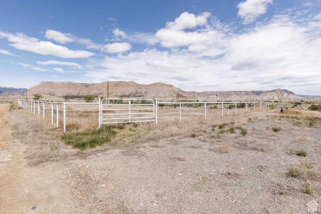 View of yard featuring fence, a mountain view, and a view of countryside