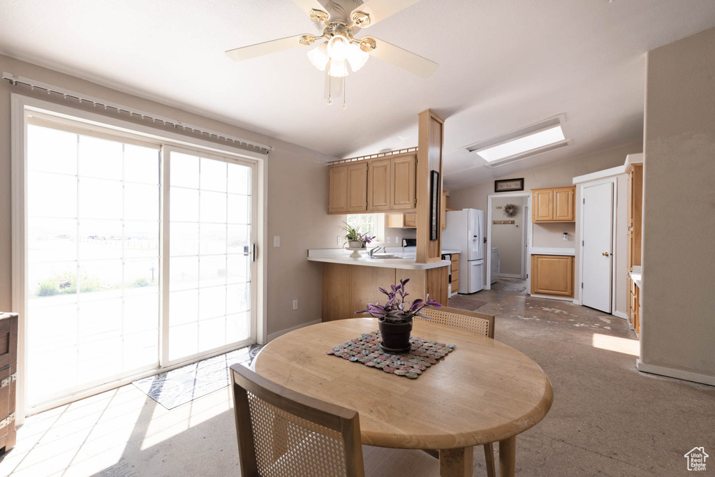 Dining area featuring vaulted ceiling and ceiling fan