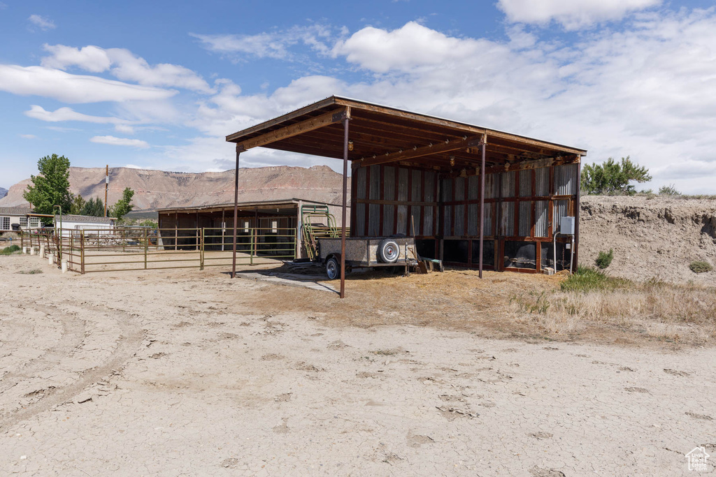 View of outdoor structure with a mountain view, an outdoor structure, an exterior structure, and a detached carport