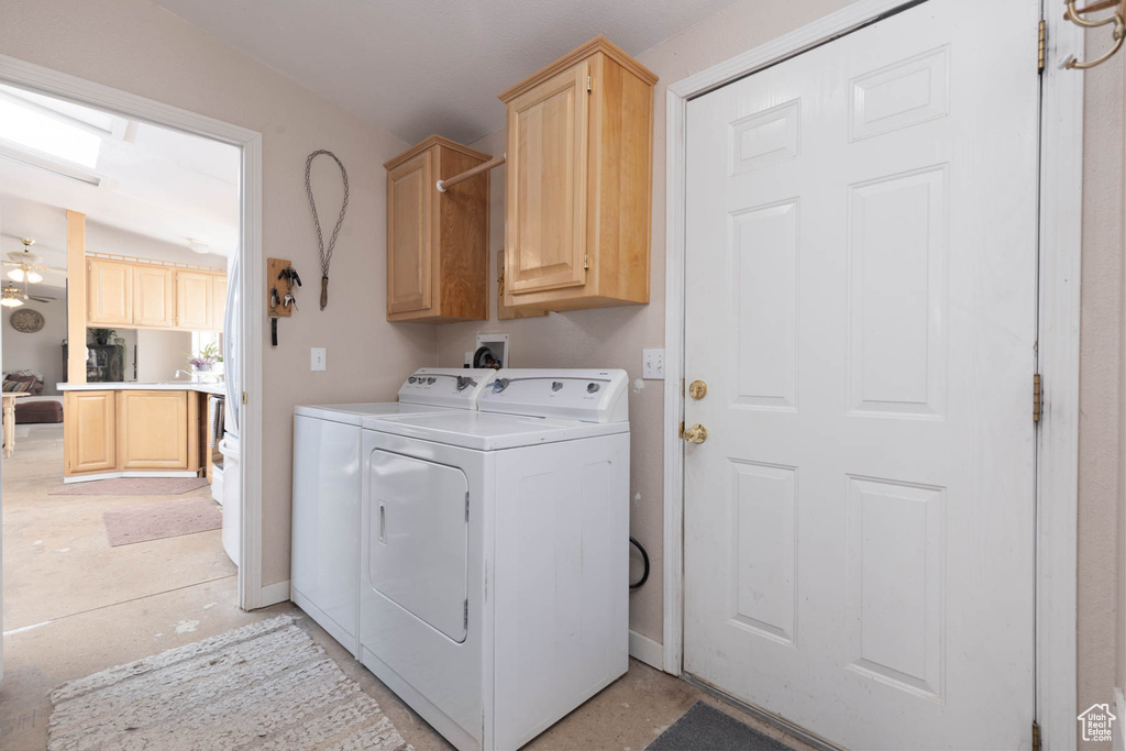 Laundry area with cabinet space and washing machine and dryer