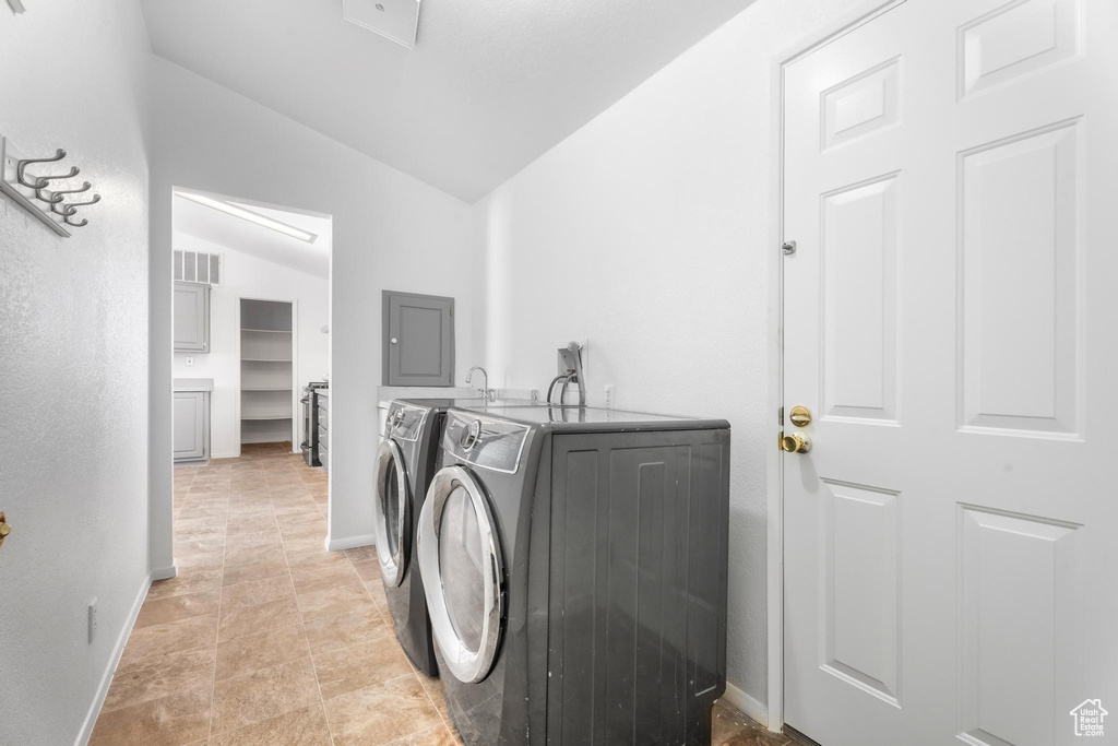 Laundry room featuring separate washer and dryer and baseboards