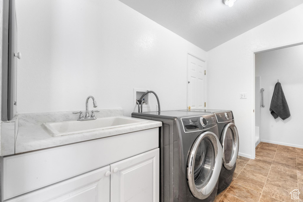 Laundry area with cabinet space and independent washer and dryer