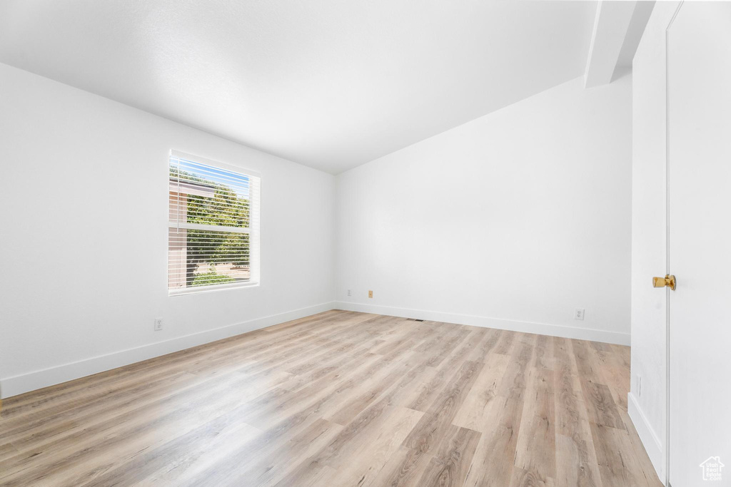 Empty room with light wood finished floors and baseboards