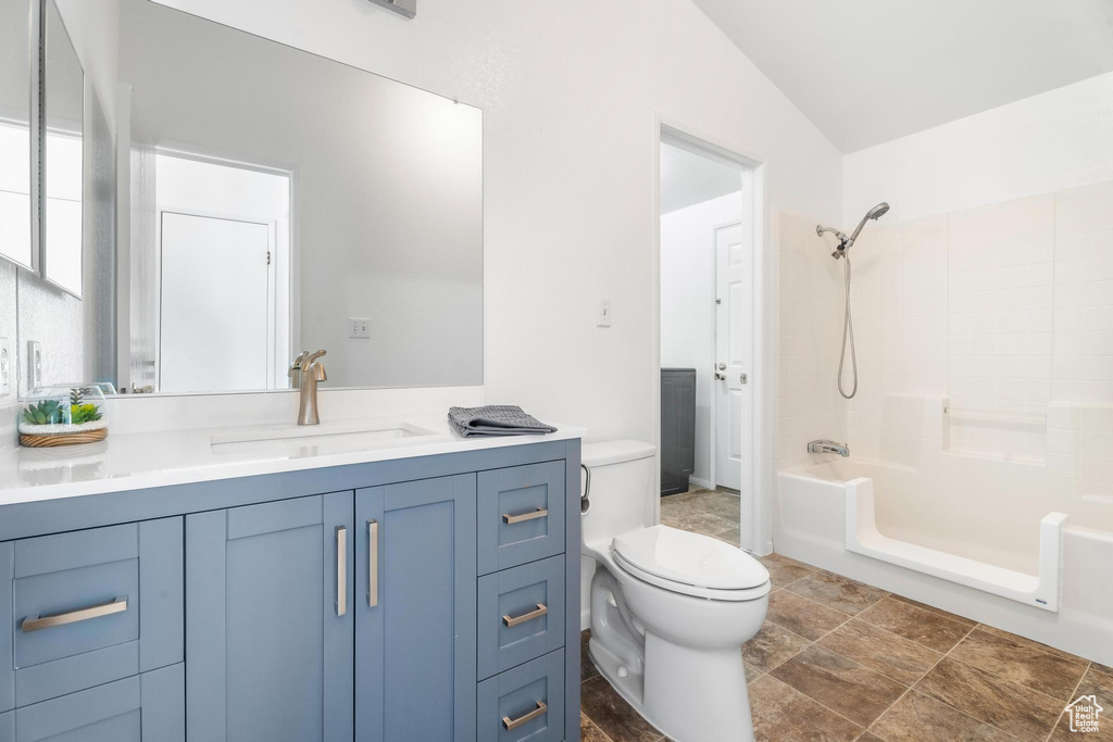 Full bathroom featuring toilet, vanity, and  shower combination