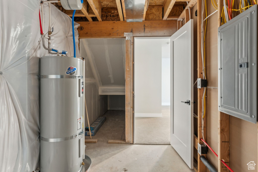 Below grade area featuring strapped water heater and electric panel