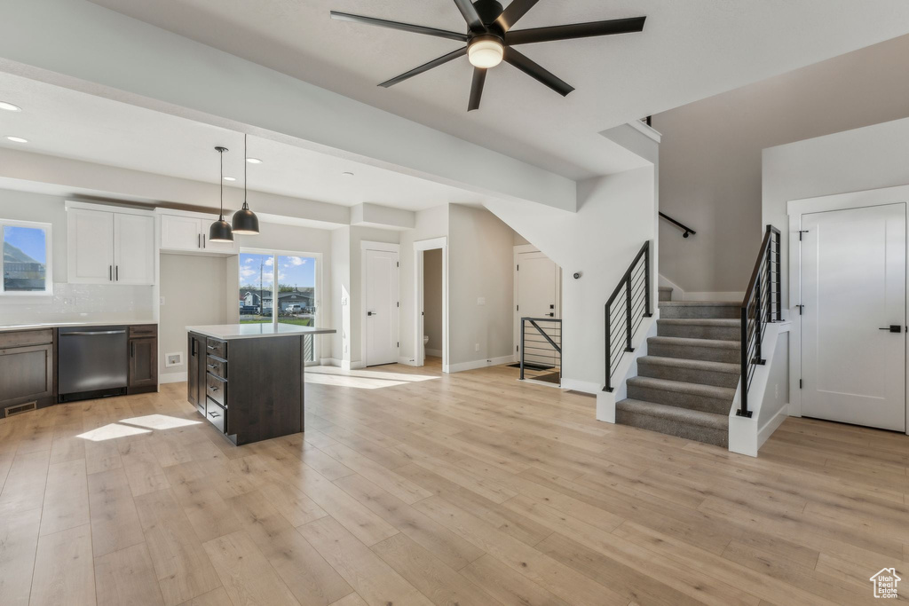 Kitchen featuring stainless steel dishwasher, a ceiling fan, decorative light fixtures, light wood-type flooring, and recessed lighting