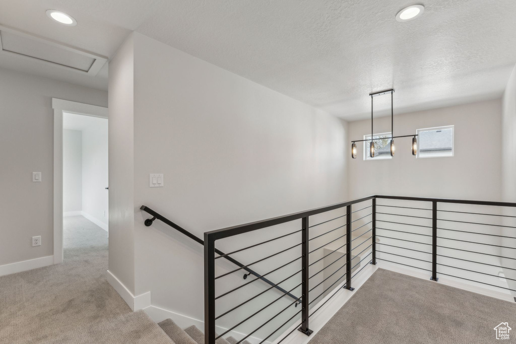 Staircase featuring carpet, recessed lighting, baseboards, attic access, and a textured ceiling