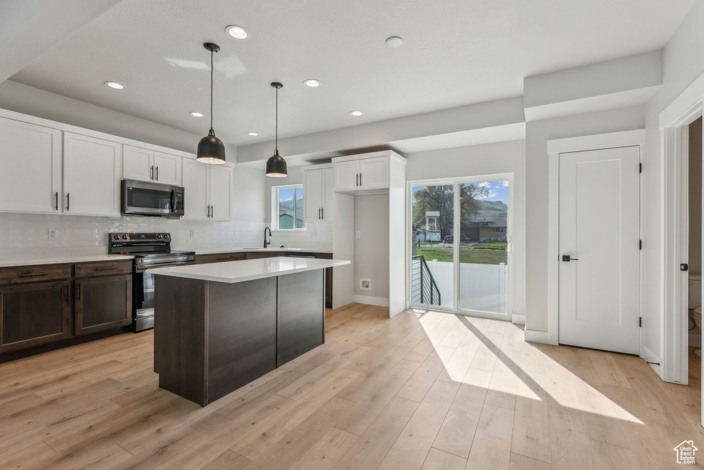 Kitchen with appliances with stainless steel finishes, a sink, healthy amount of natural light, recessed lighting, and decorative backsplash