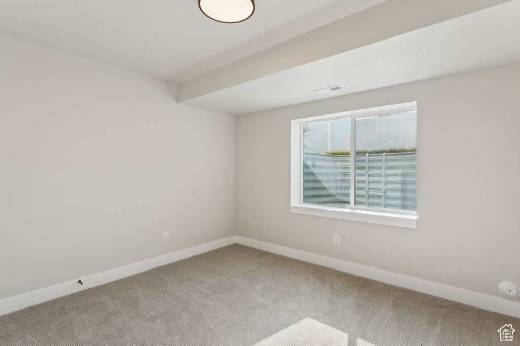 Unfurnished room featuring carpet floors and baseboards