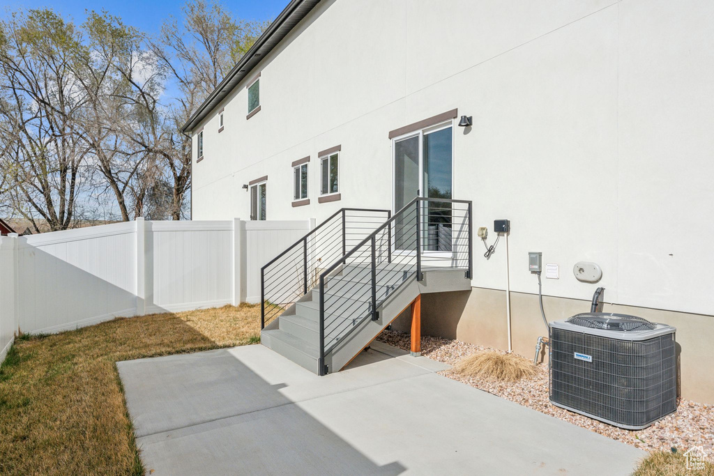 View of patio / terrace with central air condition unit and fence