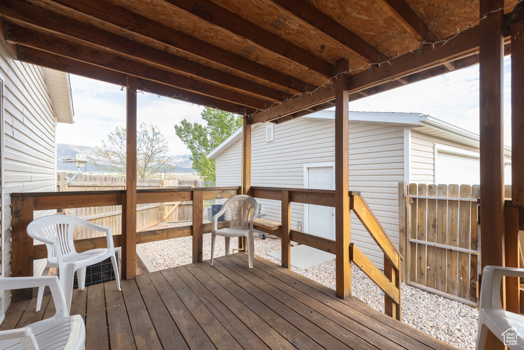 Wooden terrace featuring fence and a mountain view