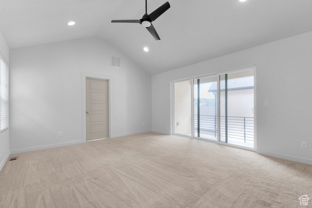 Empty room with vaulted ceiling, ceiling fan, light colored carpet, baseboards, and recessed lighting