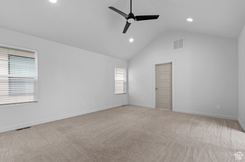 Unfurnished bedroom with lofted ceiling, recessed lighting, carpet floors, baseboards, and ceiling fan