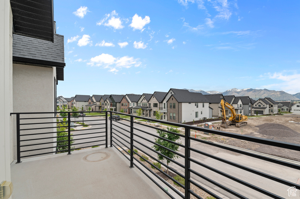 Balcony featuring a residential view and a mountain view