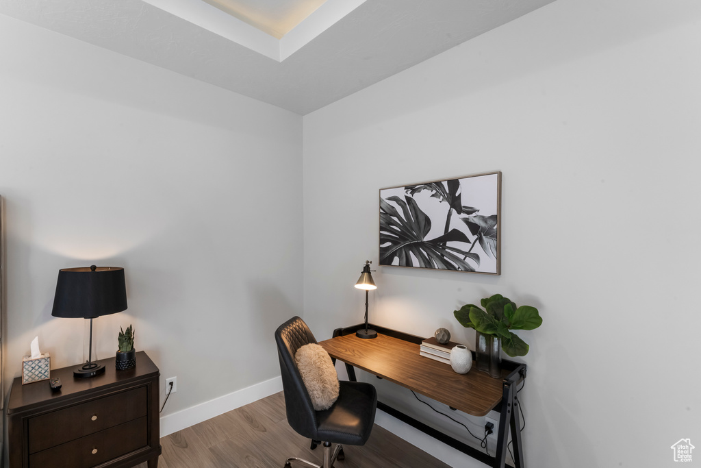 Office space featuring wood finished floors and baseboards