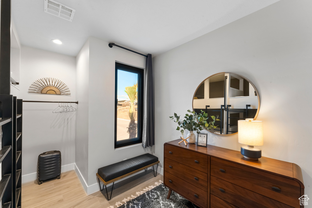 Living area featuring light wood-style flooring, baseboards, and recessed lighting