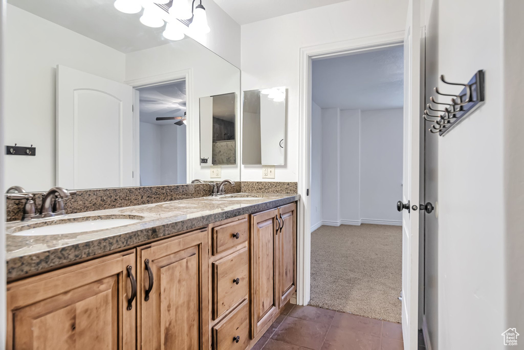 Bathroom featuring tile patterned floors, double vanity, and a ceiling fan