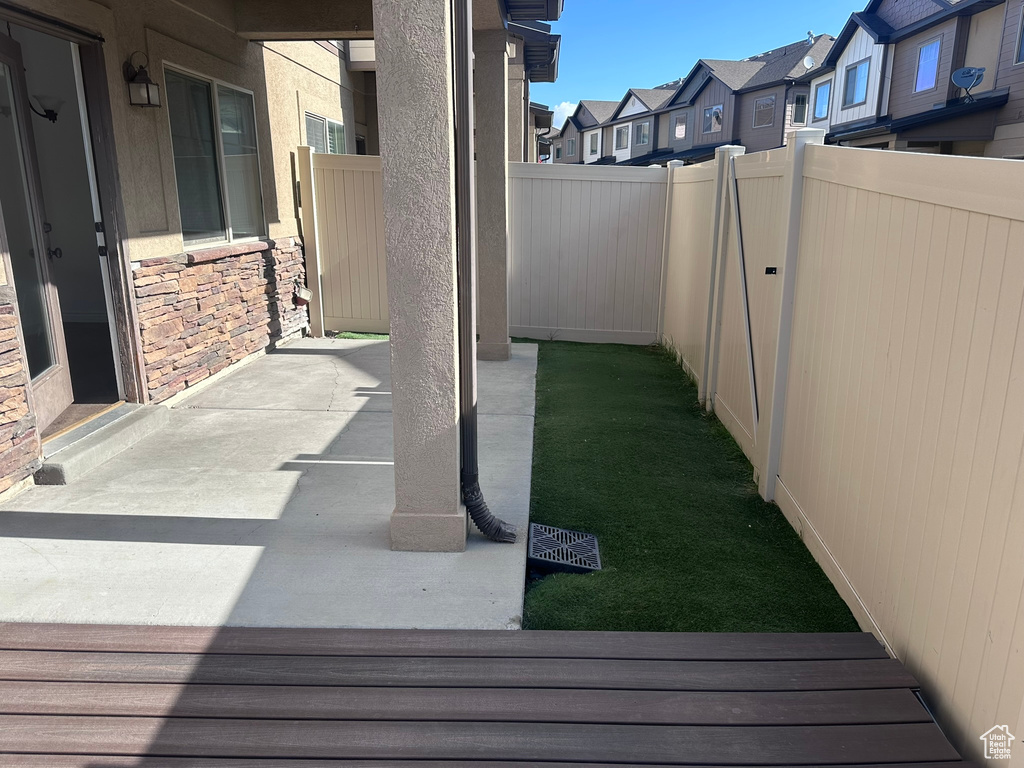 View of patio with fence and a residential view