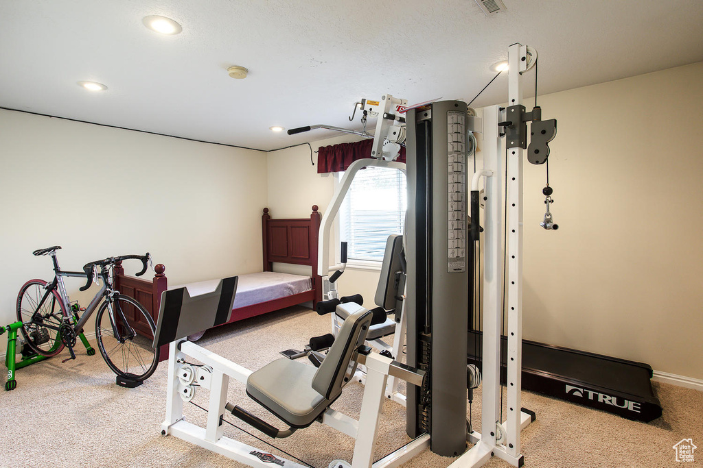 Workout area with carpet floors, recessed lighting, and baseboards