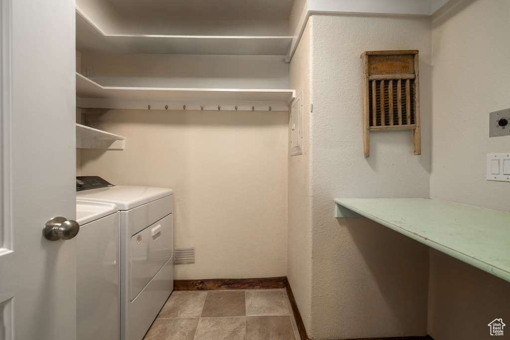 Laundry area with separate washer and dryer and baseboards