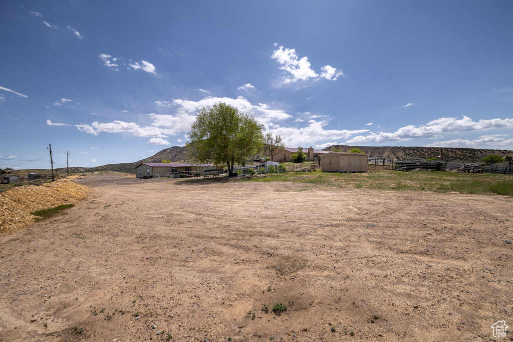 View of yard featuring fence, an outbuilding, and a storage shed