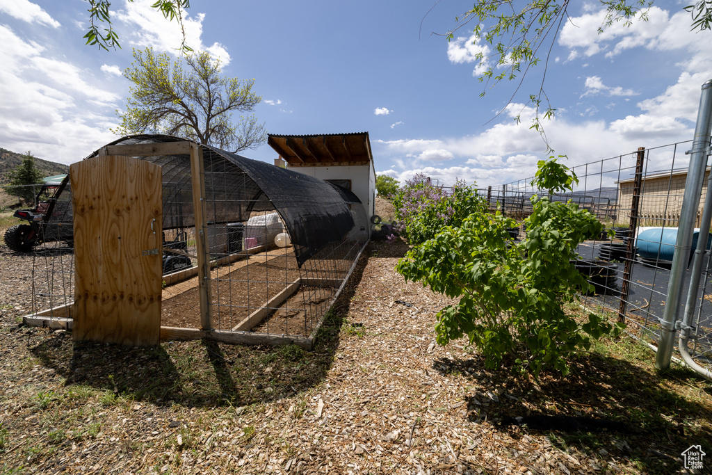 View of yard with exterior structure, an outdoor structure, and fence