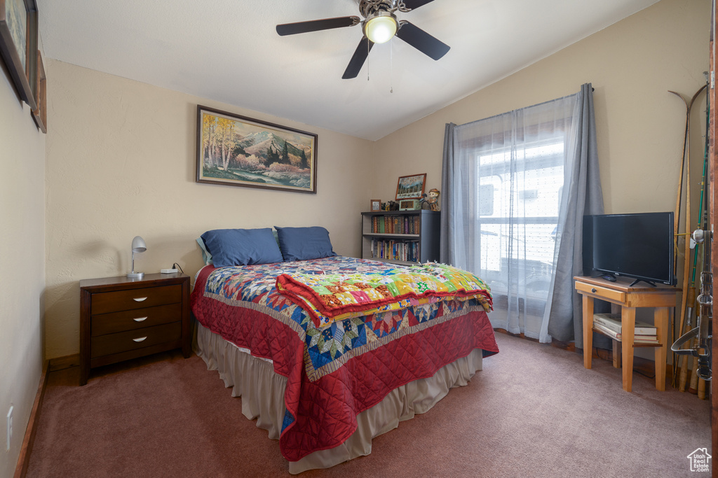 Bedroom featuring lofted ceiling, carpet, and a ceiling fan