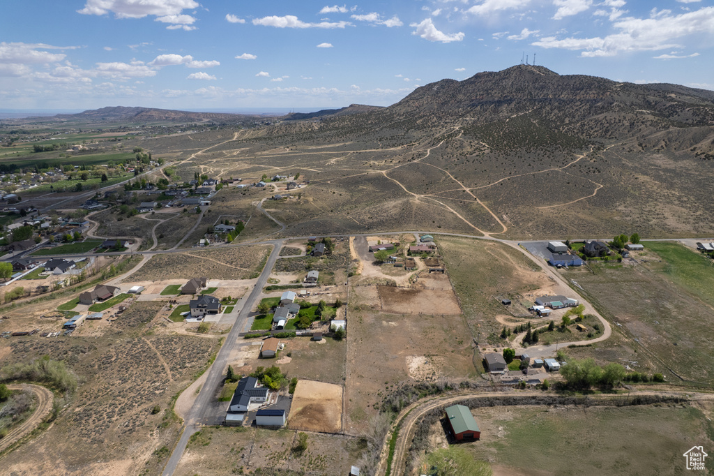 Aerial view of property and surrounding area with a mountain backdrop