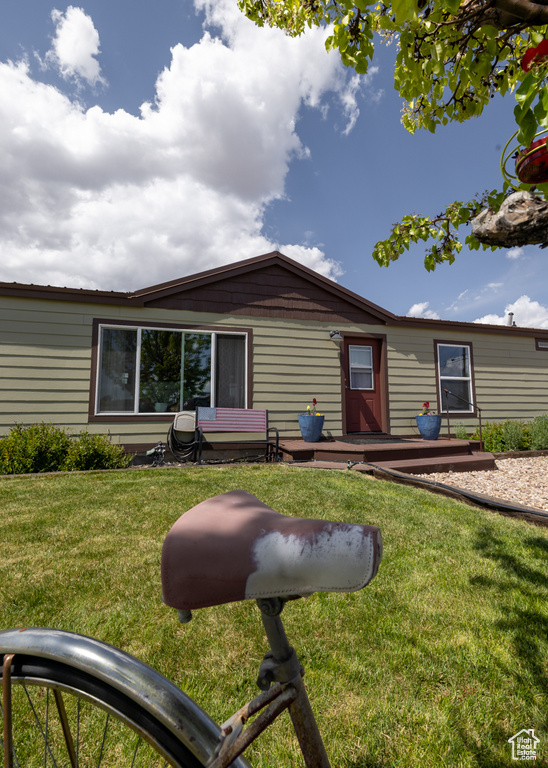 View of front of property with a front yard and a deck