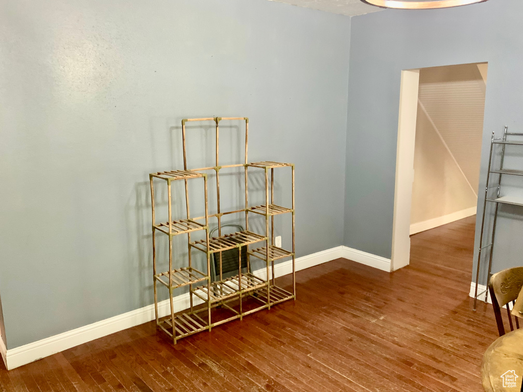 Empty room featuring hardwood / wood-style floors and baseboards