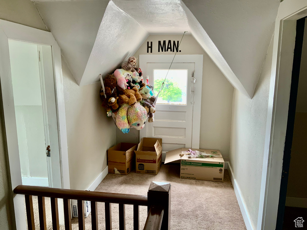 Additional living space featuring carpet flooring, lofted ceiling, and baseboards
