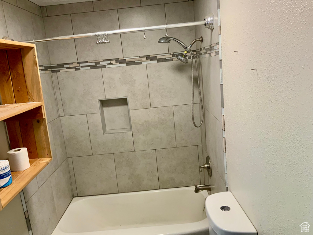Full bathroom featuring bathtub / shower combination and toilet