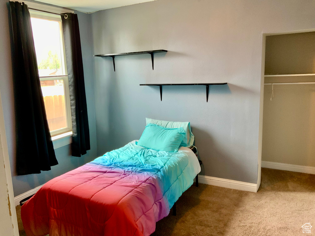 Bedroom with carpet and baseboards