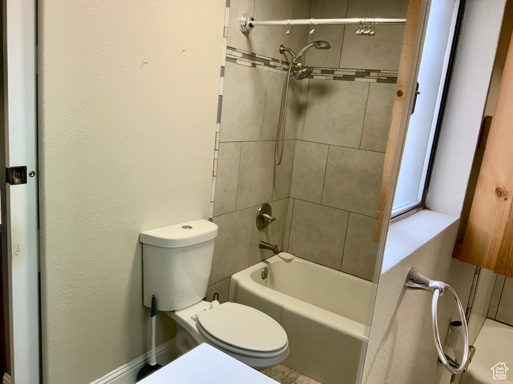 Full bath with toilet and bathtub / shower combination