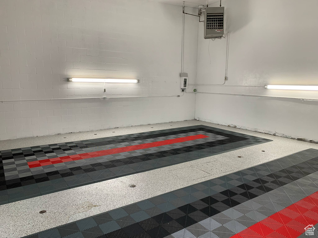 Garage featuring a heating unit